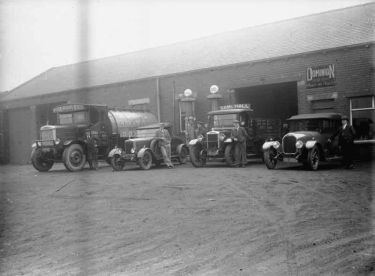Garage, with cars & tanker outside