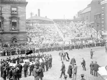 Royal Visit, King George V and Queen Mary, Town Hall, Dewsbury. Stands filled with people and band, awaiting the arrival of the King and Queen.