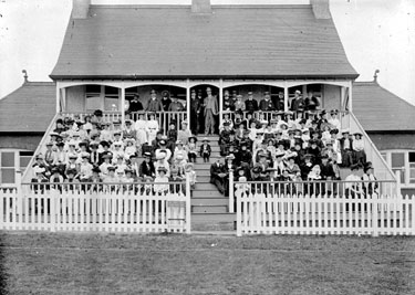 Crowd in ladies' stand at cricket match