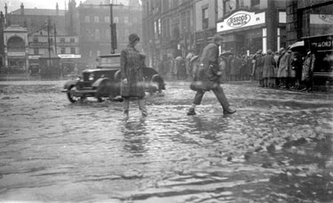 Crowd outside Jessop's Tailors during flood, Dewsbury
