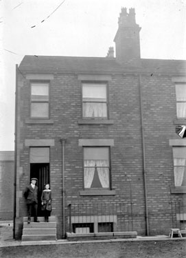 Two men in front of terraced house, Dewsbury?