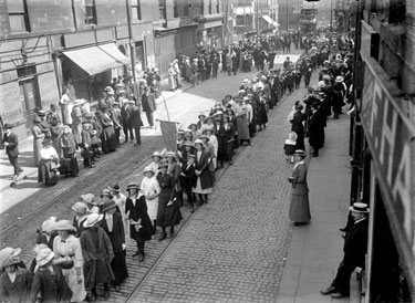 Procession of women outside Hargreaves Game & Poultry store, Halifax Road, Dewsbury