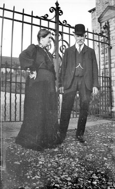 Man and woman in front of gates