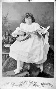 Portrait of young girl playing mandolin