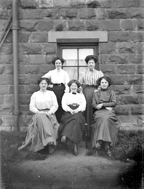 Group of women outside house