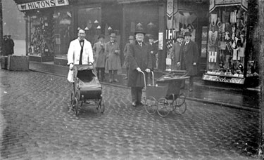 Two men with prams outside Hiltons, Market Place, Dewsbury
