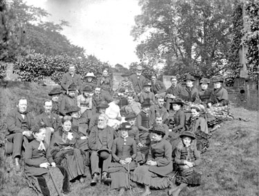 Group of Men and Women sitting outside
