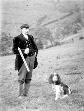Man with gun and dog