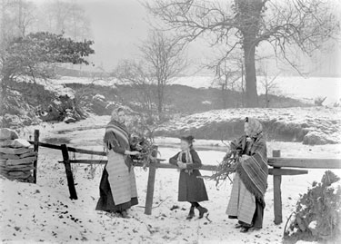 Women and Child collecting firewood in snow