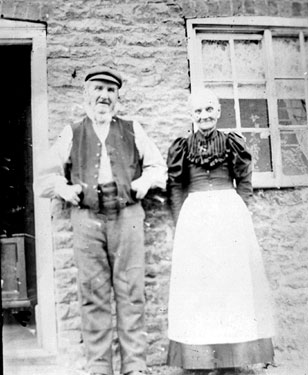 Man and Woman standing outside house