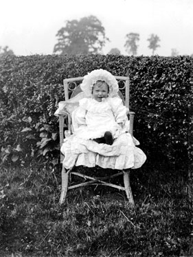 Young Girl sitting in Garden