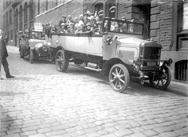 Charabanc with passengers, outside R S Balden & Sons Valuers and R.A.O.B. Club, Dewsbury