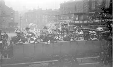 Charabanc with children holding flags