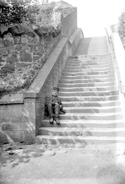 Beggar sitting on steps of Stirling Castle