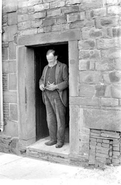 Man stood in doorway, Rhuddlan, North Wales