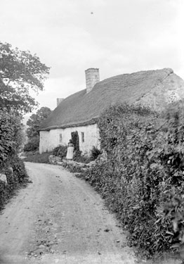Woman outside cottage, North Wales