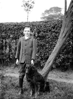 Boy with dog in garden