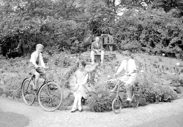 Children on bicycles in Mrs Heaton's garden
