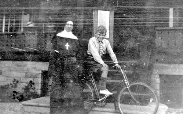 Nun with boy on bike