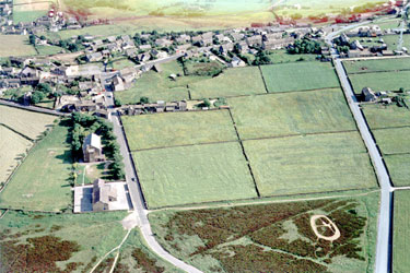 Aerial view of Scapegoat Hill Infants & Junior School, School Road, Scapegoat Hill, showing Halifax Road to the right and High Street at the top