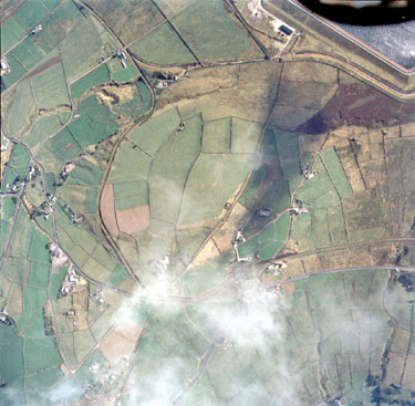 Aerial view of Marsden showing Meltham Road coming in middle right and joining Chain Road, Krives Lane running up middle towards Deer Hill Reservoir