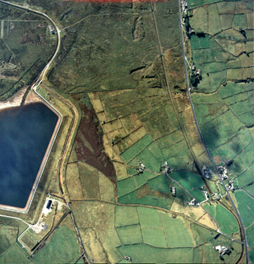 Aerial view of Deer Hill Reservoir, Marsden showing Meltham Road on right