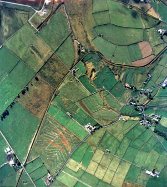 Aerial view of Marsden showing Slaithwaite Road middle bottom and edge of Deer Hill Reservoir top left