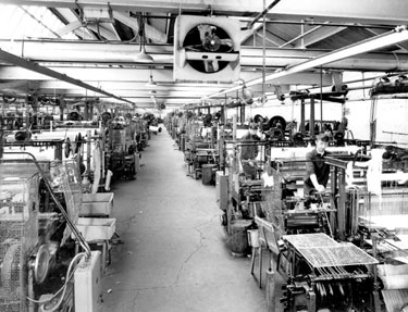 Weaving shed - weaver S. Rainbird, tuner L. Norman, in distance left L. Morris and right F. Earnshaw. By 1969 all sixteen double shuttle looms had been motorised and made semi-automatic