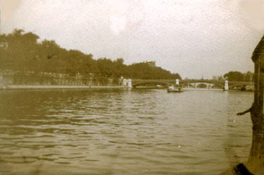 Wheelwright Grammar School Photo Album: 1920s/30s - St. Cloud - Paris by boat. Taken en route on our boat going up the Seine, the twin towers of Notre Dame are just visable in the distance