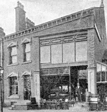 J. Shaw, Son & Co - Showroom, Huddersfield Road, Holmfirth, (now the library). Johnny Shaw in the photo made and sold furniture.