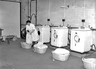 Mill laundry, Huddersfield (putting clothes in Bendix) 	