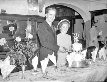 Thornton-Ives Wedding Couple cutting cake 	