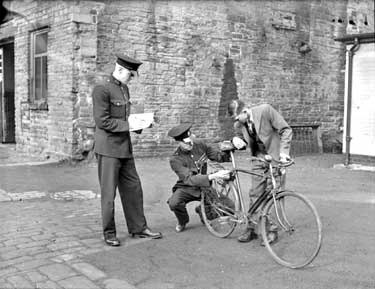 Policemen checking Bicycle 	