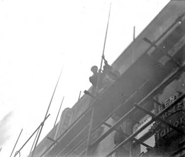 Men working on scaffold 	