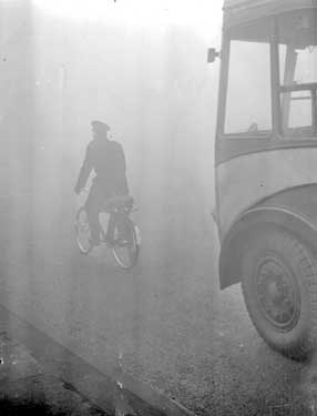 Bicycle leading Bus in the fog 	