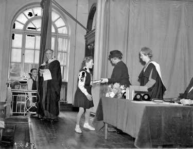 Schoolgirl receiving Award 	