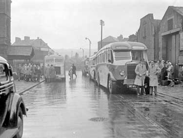 Holiday-makers boarding bus for Blackpool 	