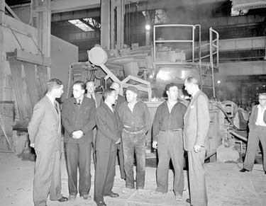 Group of Men in factory 	