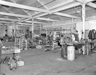 Men at work in factory 	