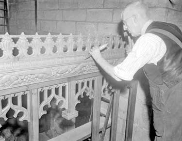 Man carving fretwork in Church 	