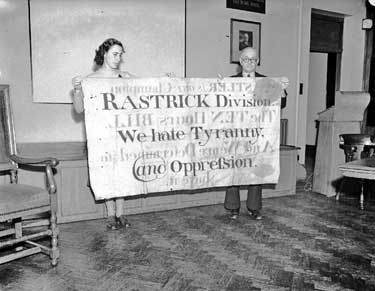 Oastlers banner for Social Reform (1832) held by Tolson Museum staff 	