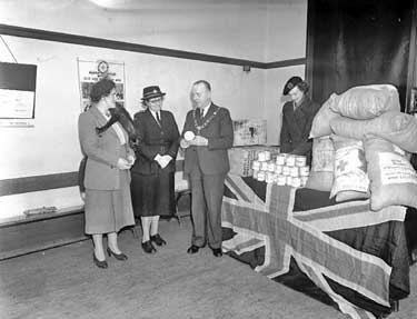 Mayor with women of New Zealand Red Cross, Huddersfield Red Cross and W.V.S. at Red Cross Headquarters, Westgate with New Zealand food and clothing gifts 	
