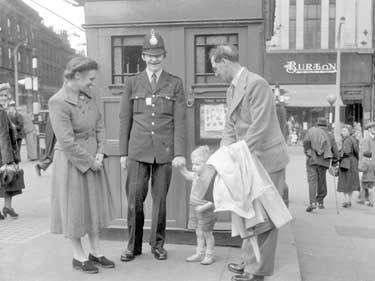 Policeman with child and couple, Market Place, Huddersfield 	