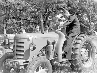 Men on tractor 	