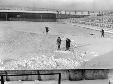 Clearing snow at Town Ground, Leeds Road, Huddersfield 	