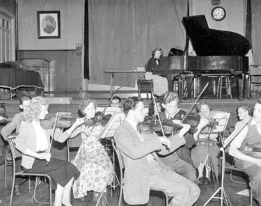 Violinists at Technical College concert rehearsal 	