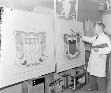 Artist painting Coats of Arms 	