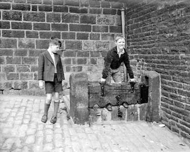 Two boys in stocks 	