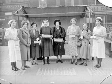 Mayoress with group of ladies selling flags in Market Place, Huddersfield 	