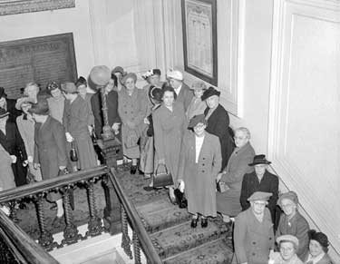 Women queueing inside Huddersfield Town Hall 	